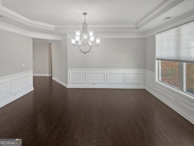 2470 Bridle Bridge Trl, Cumming, GA 30040 - unfurnished room with wainscoting, an inviting chandelier, a tray ceiling, dark wood finished floors, and ornamental molding
