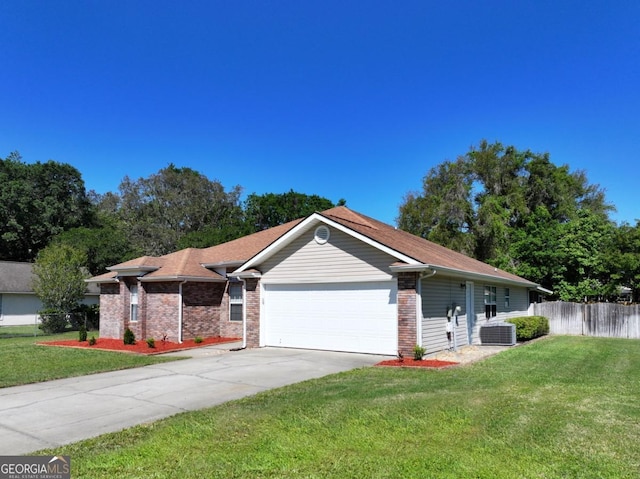 single story home with central AC unit, fence, a front yard, and a garage