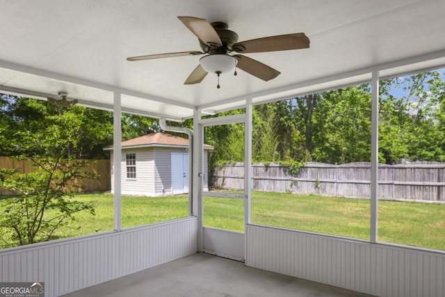 unfurnished sunroom with a ceiling fan