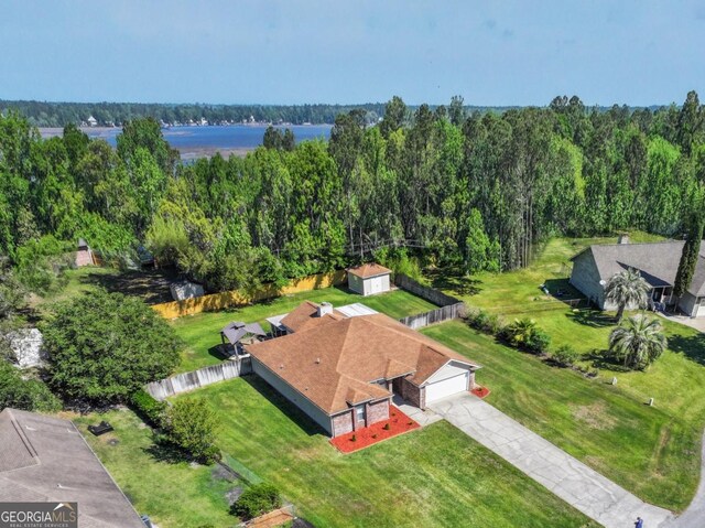birds eye view of property with a wooded view