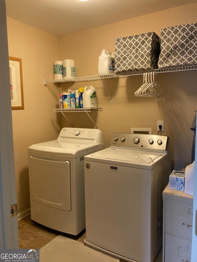 laundry area with tile patterned floors, washer and dryer, and laundry area