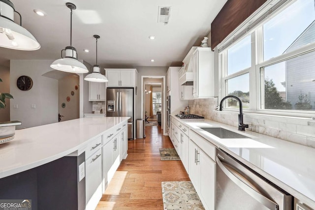 2815 Paddle Point Ln, Cumming, GA 30041 - kitchen with visible vents, a healthy amount of sunlight, stainless steel appliances, and a sink