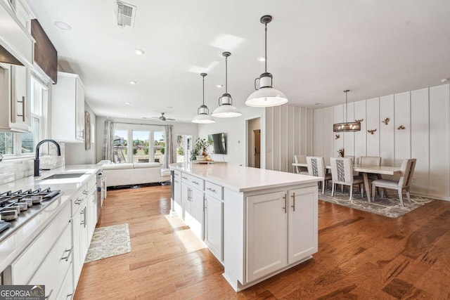 2815 Paddle Point Ln, Cumming, GA 30041 - kitchen with open floor plan, visible vents, a sink, and light wood-style floors