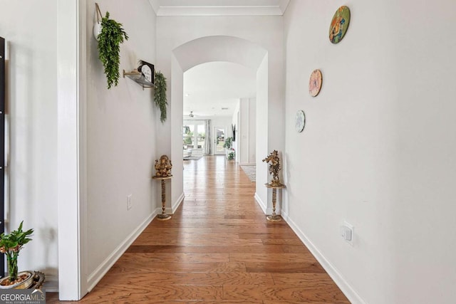 2815 Paddle Point Ln, Cumming, GA 30041 - hallway with light wood-type flooring, baseboards, arched walkways, and ornamental molding