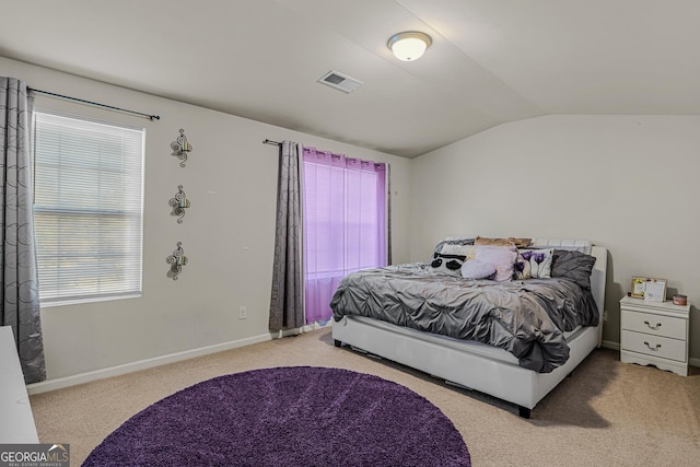carpeted bedroom featuring baseboards, vaulted ceiling, and visible vents