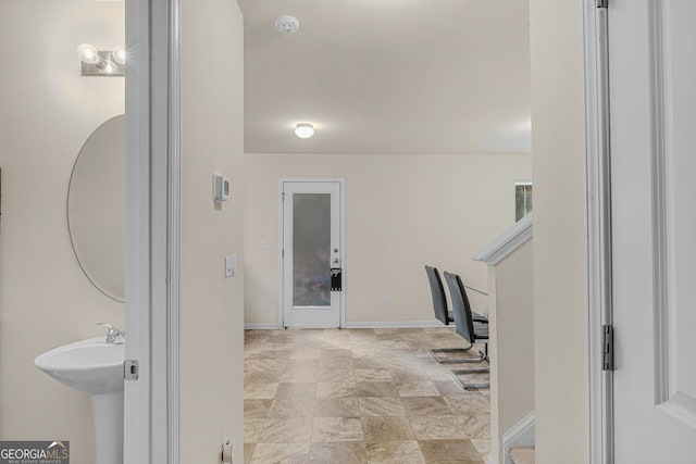 interior space with a sink and baseboards