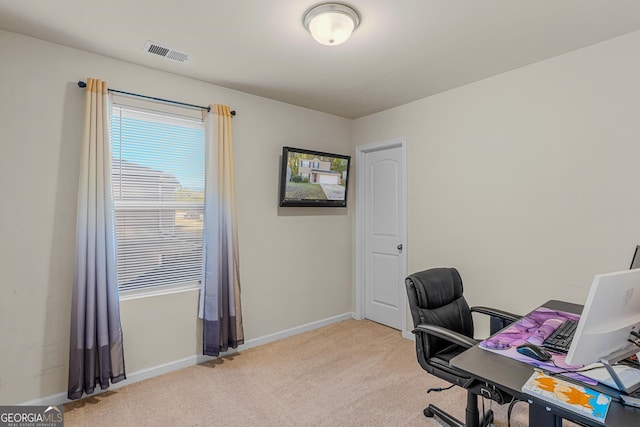 office with baseboards, plenty of natural light, light carpet, and visible vents