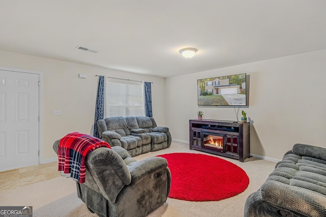 living area featuring baseboards and visible vents