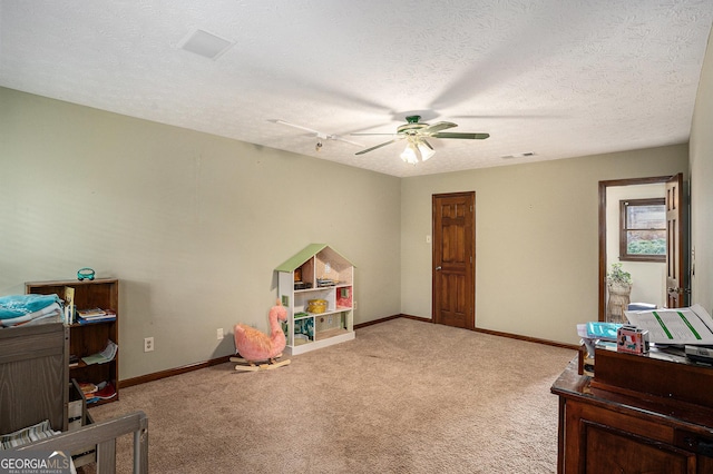 bedroom with carpet, baseboards, a textured ceiling, and a ceiling fan