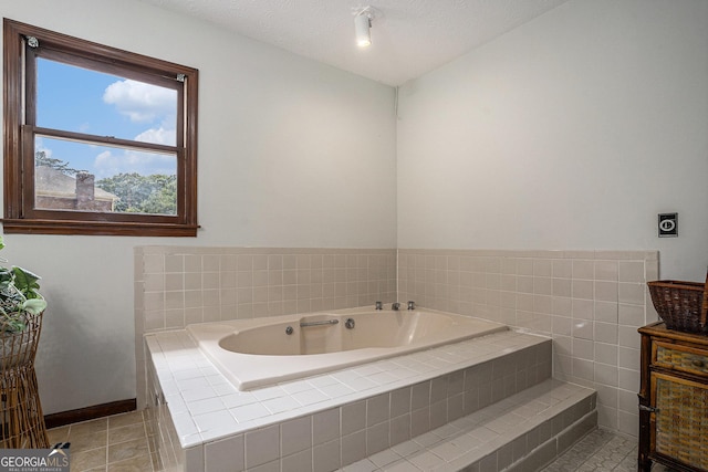 full bathroom with a bath, tile patterned floors, and baseboards