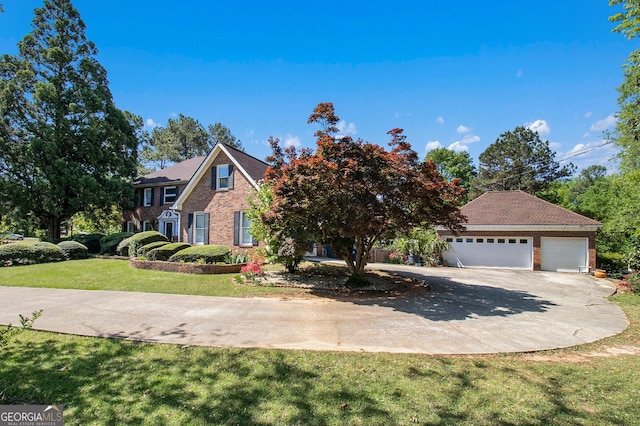 colonial house featuring driveway, brick siding, an attached garage, and a front lawn