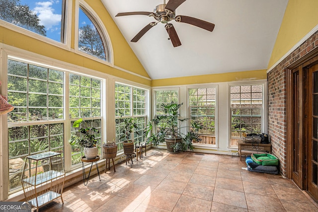 sunroom featuring high vaulted ceiling and french doors
