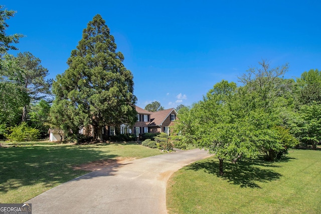 obstructed view of property featuring a front yard