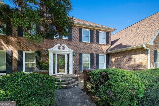 obstructed view of property featuring a front yard