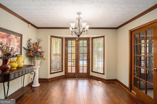 doorway to outside with baseboards, french doors, a chandelier, hardwood / wood-style floors, and a textured ceiling