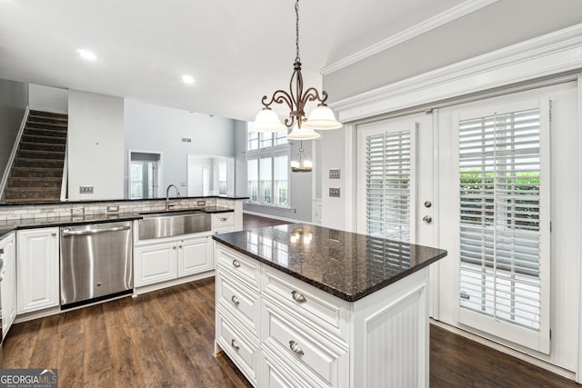3911 Delfaire Trce, Cumming, GA 30040 - kitchen with stainless steel dishwasher, a sink, a center island, dark wood finished floors, and white cabinetry