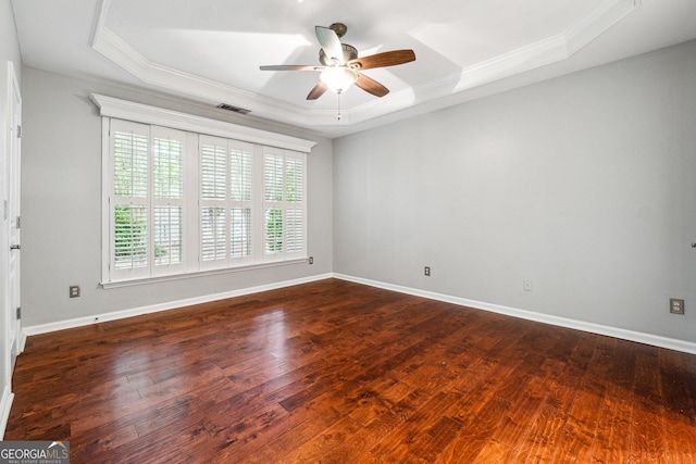 3911 Delfaire Trce, Cumming, GA 30040 - empty room with a tray ceiling, ceiling fan, crown molding, dark wood-style floors, and baseboards