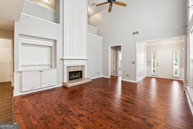 3911 Delfaire Trce, Cumming, GA 30040 - unfurnished living room featuring ceiling fan, a high ceiling, dark wood-style floors, a tile fireplace, and baseboards