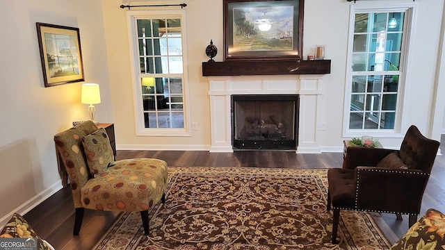 181 Bagley Rd, Eatonton, GA 31024 - sitting room featuring baseboards, a fireplace, and dark wood finished floors