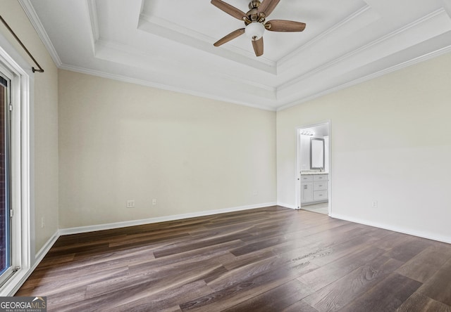 181 Bagley Rd, Eatonton, GA 31024 - spare room featuring a ceiling fan, a tray ceiling, dark wood-type flooring, and ornamental molding