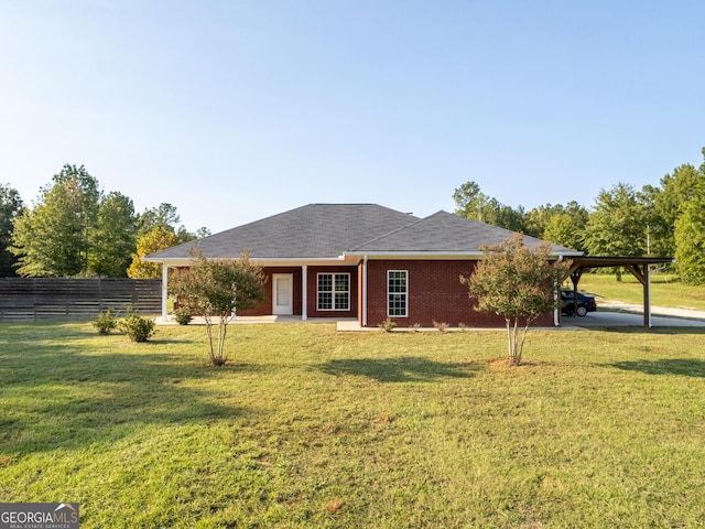 181 Bagley Rd, Eatonton, GA 31024 - rear view of house with brick siding, a yard, a carport, and fence
