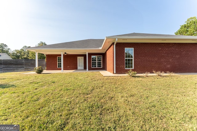 181 Bagley Rd, Eatonton, GA 31024 - view of front of house featuring fence, a patio area, brick siding, and a front yard