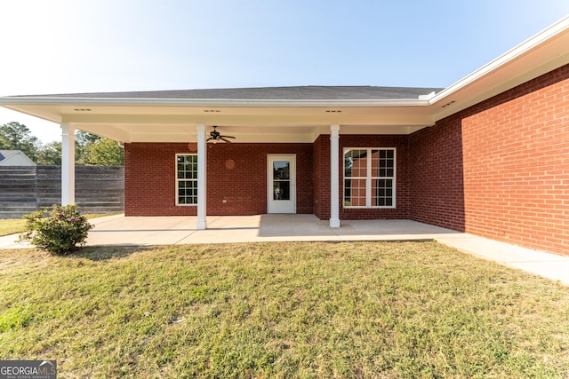 181 Bagley Rd, Eatonton, GA 31024 - back of house with fence, brick siding, a yard, and a patio