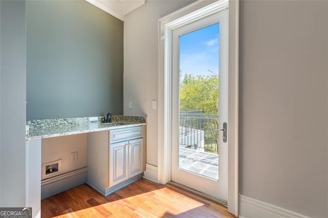 6509 Lily Trl, Fairburn, GA 30213 - doorway to outside with light wood-style floors and bar with sink