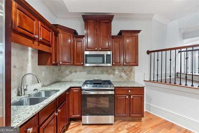 6509 Lily Trl, Fairburn, GA 30213 - kitchen with appliances with stainless steel finishes, light wood-type flooring, and light stone countertops