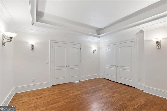 6509 Lily Trl, Fairburn, GA 30213 - unfurnished bedroom featuring a raised ceiling and wood finished floors