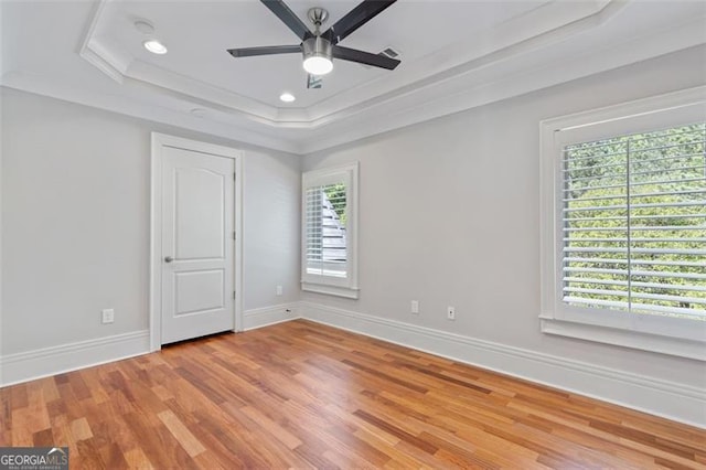 6509 Lily Trl, Fairburn, GA 30213 - unfurnished bedroom with a raised ceiling, multiple windows, light wood-type flooring, recessed lighting, and ornamental molding