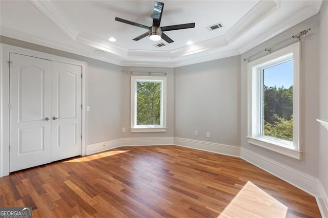 6509 Lily Trl, Fairburn, GA 30213 - unfurnished bedroom featuring crown molding, a raised ceiling, wood finished floors, and ceiling fan