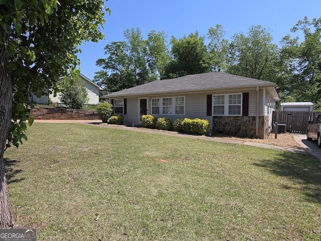 single story home with central AC, stone siding, a front yard, and fence
