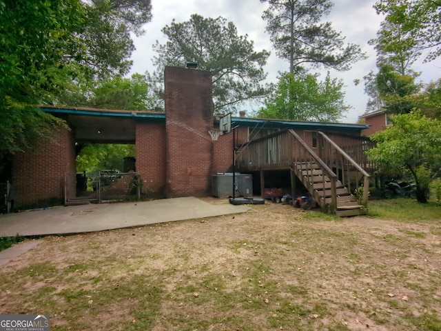 3033 Manchester Dr, Macon, GA 31206 - back of house featuring stairway, a patio area, and a chimney