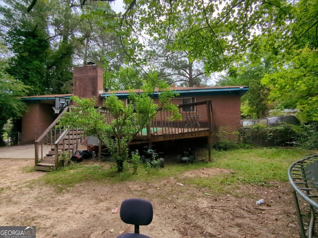 3033 Manchester Dr, Macon, GA 31206 - back of property with brick siding, stairs, a chimney, and a deck