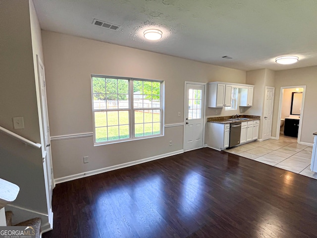 417 Bell Flower Trl, Locust Grove, GA 30248 - kitchen featuring white cabinets, light wood finished floors, visible vents, stainless steel dishwasher, and a sink