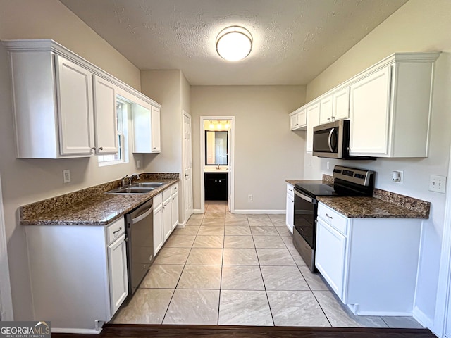 417 Bell Flower Trl, Locust Grove, GA 30248 - kitchen featuring a sink, a textured ceiling, marble finish floor, baseboards, and appliances with stainless steel finishes