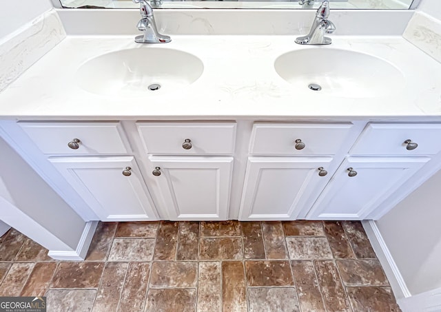 417 Bell Flower Trl, Locust Grove, GA 30248 - bathroom with baseboards, a sink, and double vanity