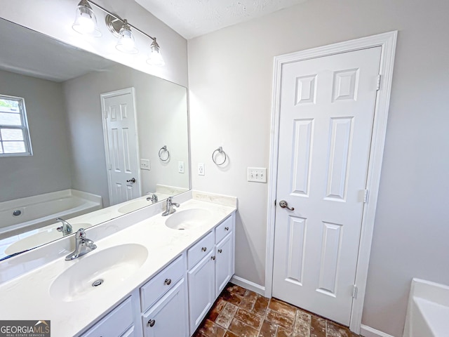 417 Bell Flower Trl, Locust Grove, GA 30248 - bathroom with a garden tub, a sink, double vanity, and baseboards