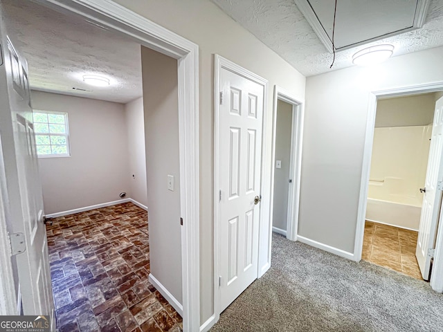 417 Bell Flower Trl, Locust Grove, GA 30248 - corridor featuring attic access, baseboards, and a textured ceiling