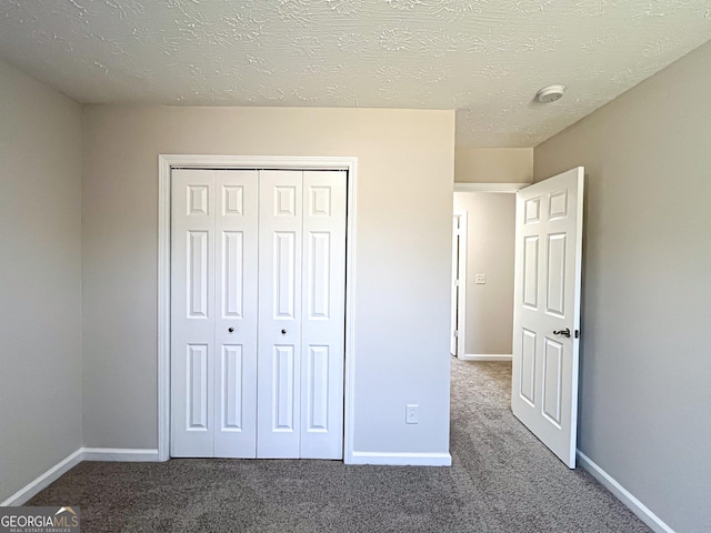 417 Bell Flower Trl, Locust Grove, GA 30248 - unfurnished bedroom with baseboards, carpet, and a closet