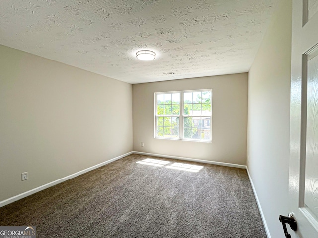 417 Bell Flower Trl, Locust Grove, GA 30248 - carpeted empty room with a textured ceiling and baseboards