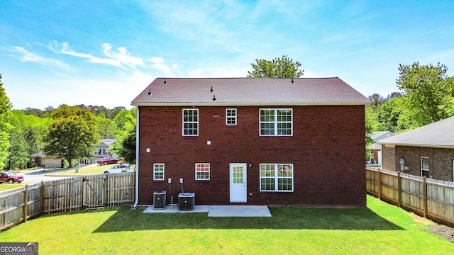417 Bell Flower Trl, Locust Grove, GA 30248 - rear view of house featuring brick siding, a yard, and central air condition unit