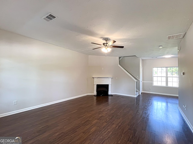 417 Bell Flower Trl, Locust Grove, GA 30248 - unfurnished living room featuring ceiling fan, baseboards, dark wood-type flooring, and visible vents