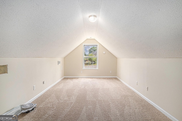bonus room featuring vaulted ceiling, baseboards, a textured ceiling, and carpet floors