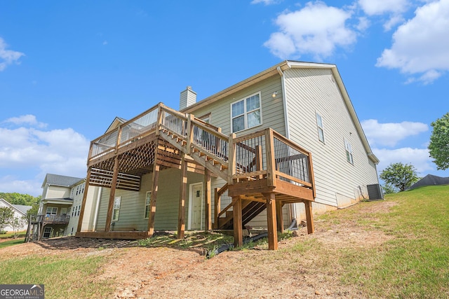 back of property with a lawn, central AC unit, and a deck
