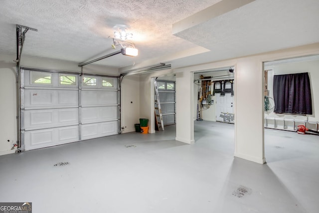 garage with baseboards and a garage door opener