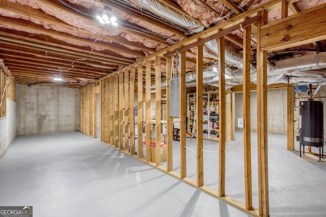 unfinished below grade area featuring water heater