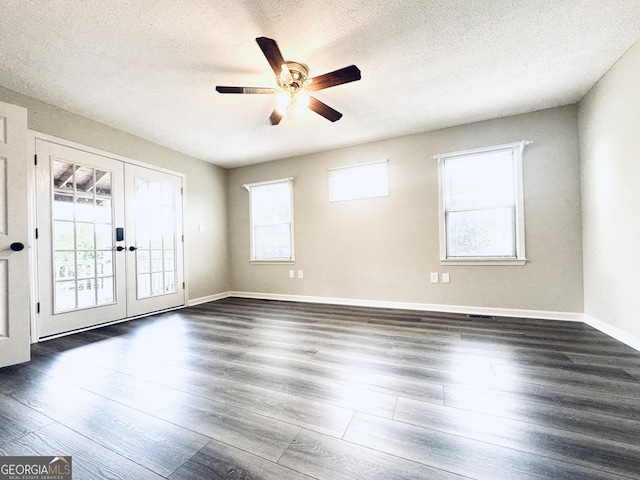 empty room featuring baseboards, ceiling fan, a textured ceiling, french doors, and dark wood finished floors