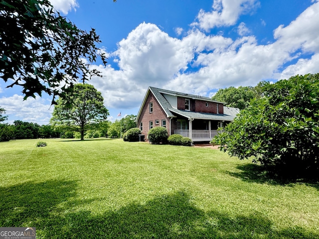 exterior space with a lawn and roof with shingles